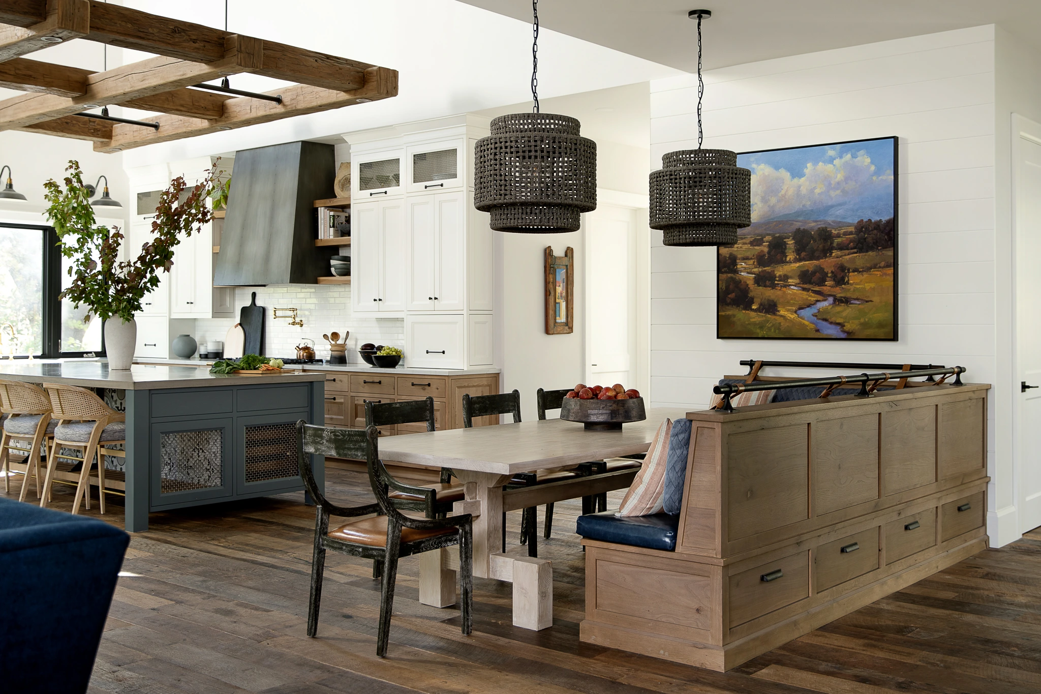 Open kitchen and dining room with white cabinets and a grey island