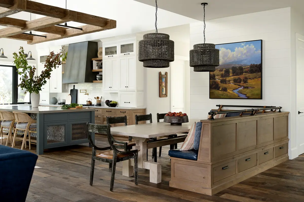 Open kitchen with white cabinets, a blue-green island and a built-in bench